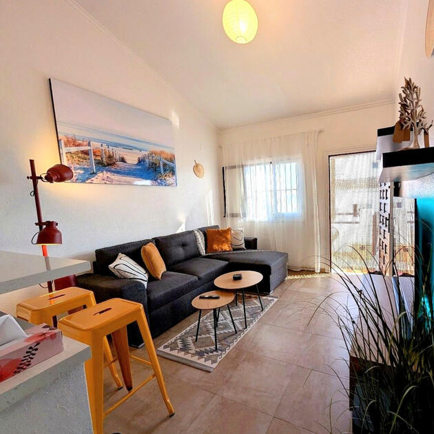 Bright living room in holiday apartment Vali Torrevieja Costa Blanca with sofa, balcony and sea - inspired decor