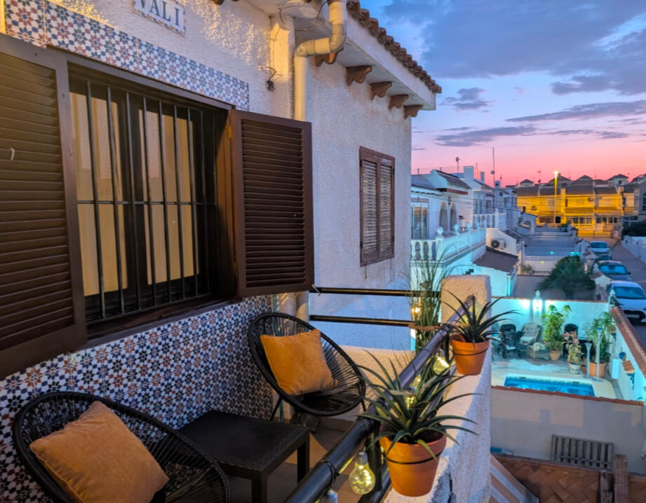 Cozy evening terrace with chairs, plants and sunset view at Apartment Vali Torrevieja